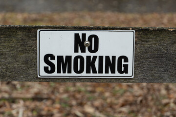 No Smoking sign on rustic fence post for information permitting smoking.