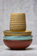 Bowls and a cup stacked in a concept photo.