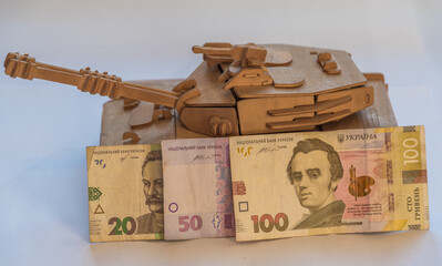 Ukrainian hryvnia and wooden tank