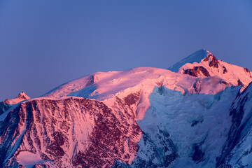 The Mont Blanc massif lit in pink by the Sun in Europe, France, Rhone Alpes, Savoie, Alps, in winter.