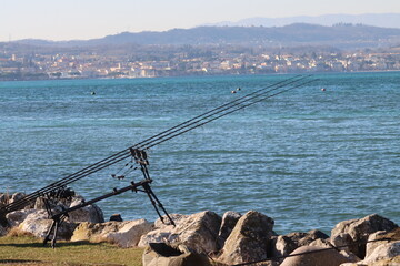 Fototapeta premium sedentary sport fishing equipment with lake landscape-