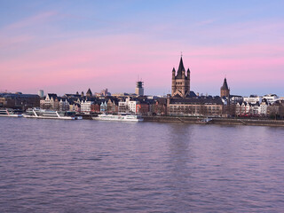Naklejka premium Panorama of the old town of Cologne on the banks of the river Rhine at dawn. View of the Fish Market and the Big Church of St. Mark.