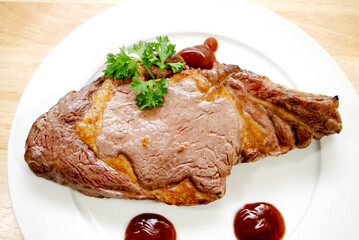 Medium Rare Broiled Beef Steak on a White Plate