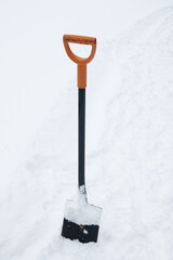 a metal shovel in the snow. Sticking out of the snow
