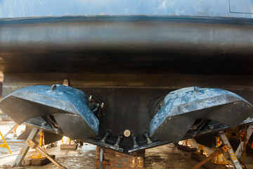 The back of the yacht with water-jet motors on it. Yacht in a dry dock.