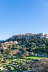 Fototapeta premium Panorama of the Acropolis. Ancient Greek Parthenon on Acropolis hill is a top landmark of Athens. Scenery of the famous monuments in the Athens center. Landscape with ruins