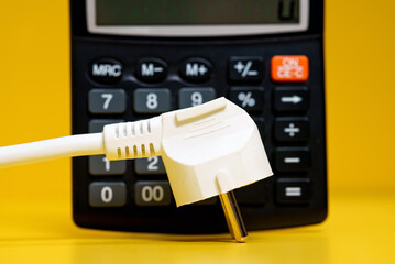 Electricity growth concept. Calculator and AC power plug.