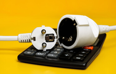 Electricity growth concept. Calculator and AC power plug.