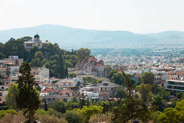 Fototapeta na wymiar Panorama of Athens from the Acropolis Hill, Greece. View of temples and houses in the center of Athens in summer.