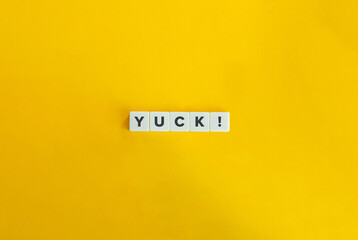 Yuck Emotional Interjection. Letter tiles on yellow background. Minimal aesthetics.