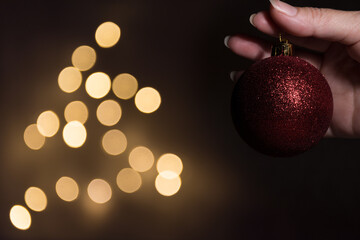 Red christmas ball with defocused lights background