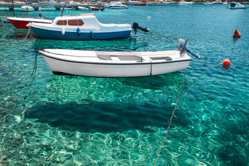 Boats in crystal clear turquoise water of Adriatic sea in Cavtat town, Dalmatia, Croatia. Summer...
