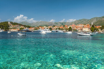 Turquoise water of Adriatic sea in Cavtat town, Dalmatia, Croatia. Touristic resort with yachts and boats.