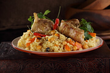 Uzbek pilaf on wooden background	