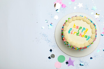 Cute bento cake with tasty cream and confetti on white background, top view