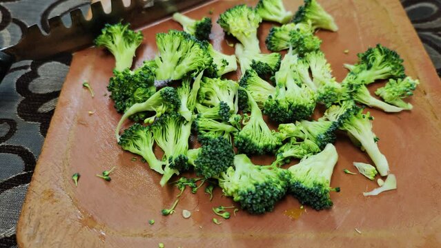 Broccoli finely chopped on aplastic vegetable cutter for stir fry