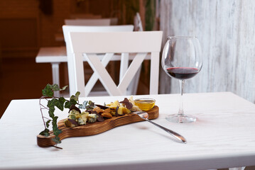 Cheese plate with red wine, restaurant interior