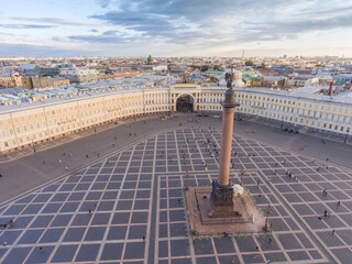 Aerial view of Palace Square and Alexander Column at sunset, a dome of Kazanskiy Cathedral on...