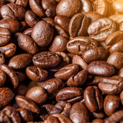 Freshly roasted coffee beans background.Dark roasted coffee beans with scoop on wooden background.