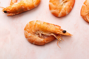 One boiled shrimp, cooked prawn on pink marble background.