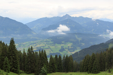 Fototapeta na wymiar Panorama view with alpine mountains and clouds in Salzburgerland, Austria