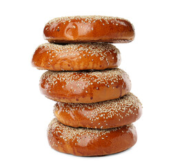 Many delicious fresh bagels on white background