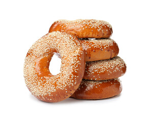 Many delicious fresh bagels on white background