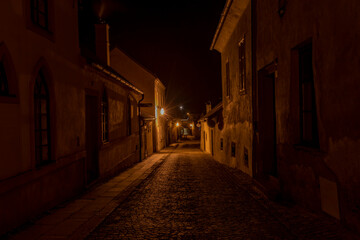 Telc town in winter night with orange street lamps