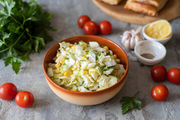 A light salad of Peking cabbage, corn and vegetables for breakfast for the whole family. Close-up