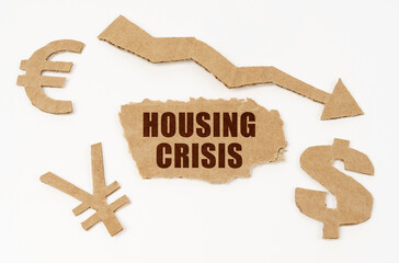 On a white background, currency symbols, an arrow and a cardboard box with the inscription - Housing Crisis