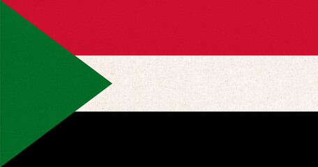 Flag of Sudan. Sudanian flag on fabric texture. National symbol