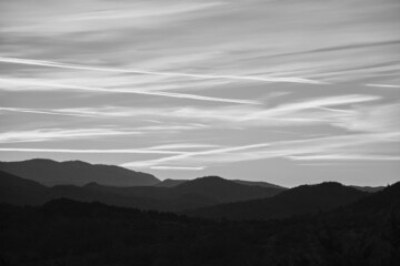 Black and white sky with linear cloud patterns at sunset 