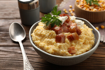 Delicious traditional Ukrainian banosh served on wooden table, closeup