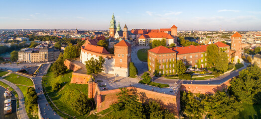Royal Wawel Cathedral and castle in Krakow, Poland. Aerial panorama in sunset light in summer with a park,  promenade and  walking people