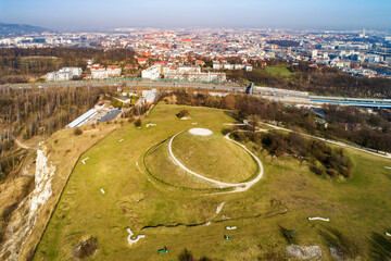Krakus Mound - Kopiec Krakusa commemorating a legendary founder of Krakow. The origin of the mound, probably early medieval kurgan, is not known. City panorama in the background - obrazy, fototapety, plakaty