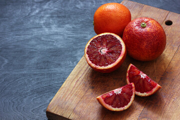 Blood red oranges. Whole and cut into pieces citrus.