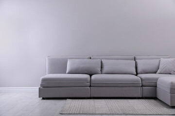 Large grey sofa in living room. Interior design