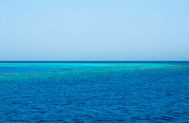 Blue sea water horizon line. Seawater background. Blue sea with little waves texture. Seawater surface texture