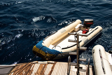 Zodiac fast boat (inflatable boat) sailing behind a diving boat in the sea