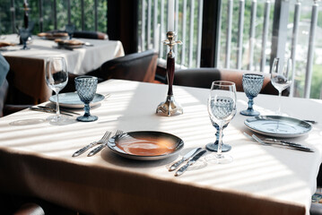 A beautifully laid table with exquisite dishes in a modern restaurant.