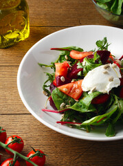 Salad with spinach, cherry tomatoes, red bell pepper, beetroot, micro greens, cheese. Homemade food. The concept of delicious and healthy food. Wooden background. Top view. Close up. Healthy nutrition