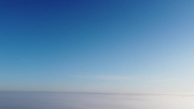 4k blue sky with sun over clouds
