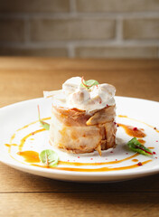 Pork meat in bacon with mushroom sauce, mushrooms. Restaurant serving of a hot meat dish. Hearty food. Lunch for a man. Delicious. Close up. Copy space. Decorated with micro-greens and red pepper peas