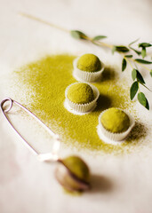 Organic natural candies made of nuts and matcha. chocolate, natural, handmade candies on a white background with sprinkles