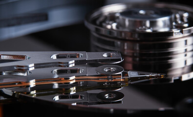 Open hard disk drive with magnetic head closeup.