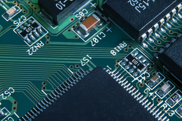 Closeup of Printed Circuit Board with processor, integrated circuits and many other surface mounted...