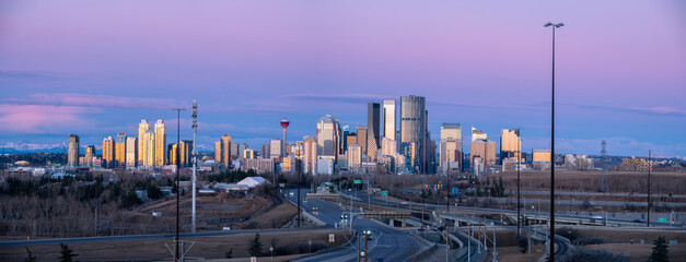 Panoramic view of Calgary's skyline at sunrise.