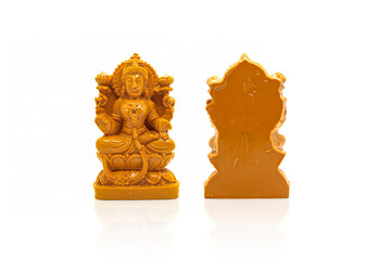 The statue of Mahalakshmi carved in brown wood is isolated with a white background with reflection...