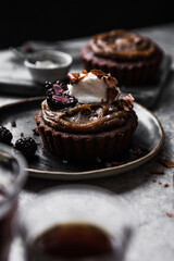 Chocolate muffin with berries and chocolate flakes for breakfast