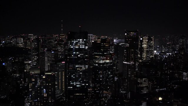 Japan modern urban skyline at night overlooking the beautiful Tokyo city. Aerial view over cityscape. Business finance and economy concept